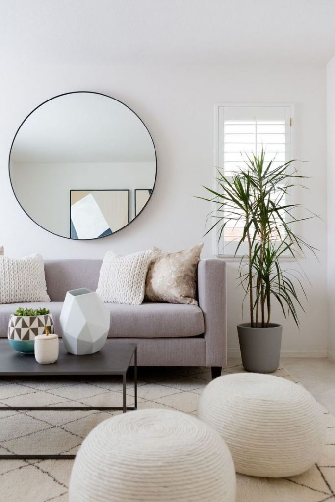 round decorative mirror makes a room brighter